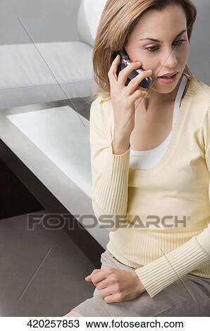 Close-up of a mid adult woman talking on a mobile phone View Large Photo Image Stock Image - Close-up of a mid adult woman talking on a mobile phone. Fotosearch