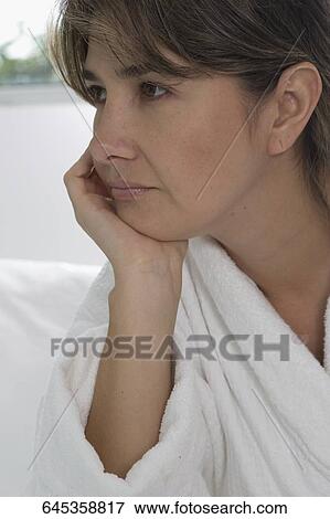 Close-up of a mid adult woman thinking View Large Photo Image Stock Photo - Close-up of a mid adult woman thinking. Fotosearch