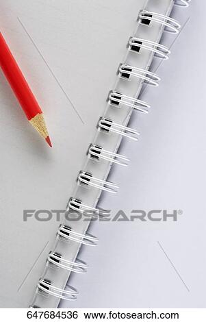 Stock Photograph - Close-up of a pencil on a spiral notebook. Fotosearch