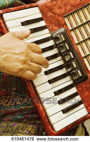 Close-up of a person's finger playing an accordion, Genoa, Italy View Large Photo Image Stock Photo - Close-up of a person's finger playing an accordion, Genoa, Italy. Fotosearch