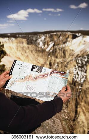 Close-up of a person's hand holding a map, Yellowstone National Park, Wyoming, USA View Large Photo Image Stock Image - Close-up of a person's hand holding a map, Yellowstone National Park, Wyoming, USA. Fotosearch