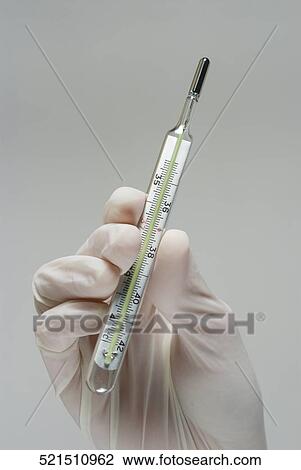 Close-up of a person's hand holding a thermometer View Large Photo Image Stock Image - Close-up of a person's hand holding a thermometer. Fotosearch