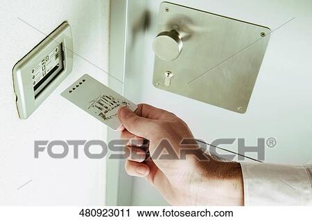 Close-up of a person's hand inserting cardkey View Large Photo Image Stock Image - Close-up of a person's hand inserting cardkey. Fotosearch
