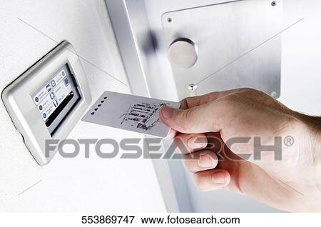 Close-up of a person's hand inserting cardkey View Large Photo Image Stock Photo - Close-up of a person's hand inserting cardkey. Fotosearch
