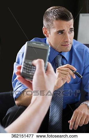 Close-up of a person's hand using a palmtop View Large Photo Image Stock Photo - Close-up of a person's hand using a palmtop. Fotosearch