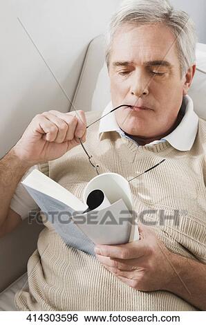 Close-up of a senior man holding a book View Large Photo Image Stock Photograph - Close-up of a senior man holding a book. Fotosearch