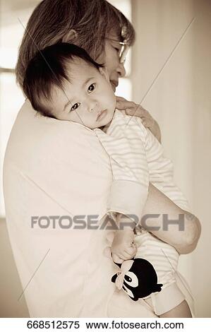 Close-up of a senior woman carrying her granddaughter View Large Photo Image Stock Photography - Close-up of a senior woman carrying her granddaughter. Fotosearch