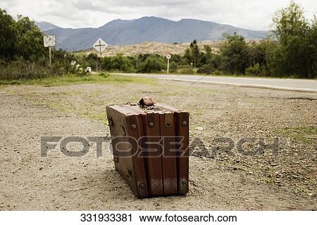 Close-up of a suitcase on the side of the road View Large Photo Image Stock Image - Close-up of a suitcase on the side of the road. Fotosearch
