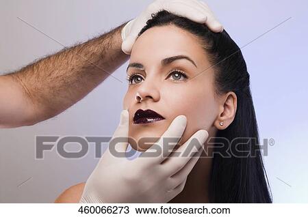 Close-up of a surgeon's hands examining a young woman View Large Photo Image Stock Image - Close-up of a surgeon's hands examining a young woman. Fotosearch