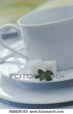 Close-up of a tea cup and saucers with sugar cubes View Large Photo Image Stock Image - Close-up of a tea cup and saucers with sugar cubes. Fotosearch