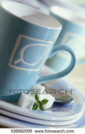 Close-up of a tea cup and saucers with sugar cubes View Large Photo Image Stock Photo - Close-up of a tea cup and saucers with sugar cubes. Fotosearch