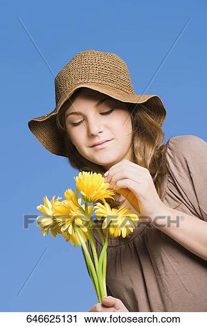 Close-up of a teenage girl holding bunch of flowers View Large Photo Image Stock Image - Close-up of a teenage girl holding bunch of flowers. Fotosearch