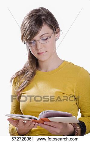 Stock Image - Close-up of a teenage girl reading a book. Fotosearch