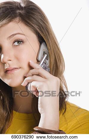 Stock Image - Close-up of a teenage girl talking on a mobile phone. Fotosearch