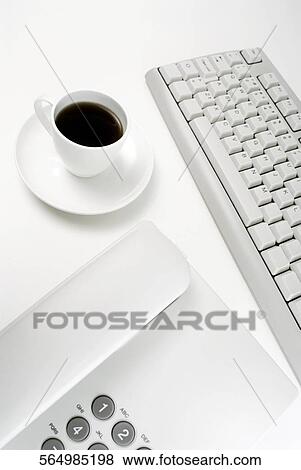 Close-up of a telephone and a computer keyboard with a cup of tea View Large Photo Image Stock Photo - Close-up of a telephone and a computer keyboard with a cup of tea. Fotosearch