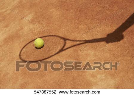 Stock Image - Close-up of a tennis ball on the court. Fotosearch