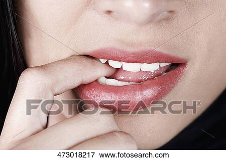 Close-up of a woman with her finger in her mouth View Large Photo Image Stock Photo - Close-up of a woman with her finger in her mouth. Fotosearch