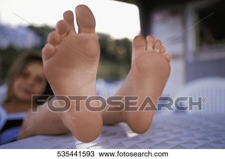 Close-up of a woman's feet on a table View Large Photo Image Stock Image - Close-up of a woman's feet on a table. Fotosearch