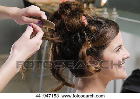 Close-up of a woman's hand combing the hair of a young woman View Large Photo Image Stock Image - Close-up of a woman's hand combing the hair of a young woman. Fotosearch