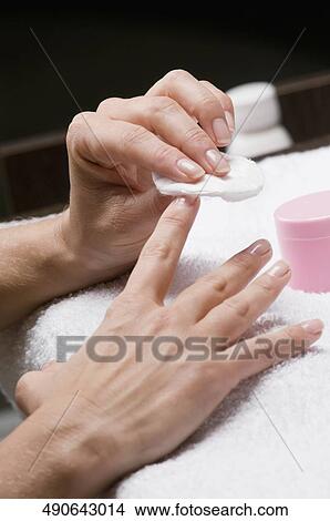 Close-up of a woman's hand removing nail polish View Large Photo Image Picture - Close-up of a woman's hand removing nail polish. Fotosearch