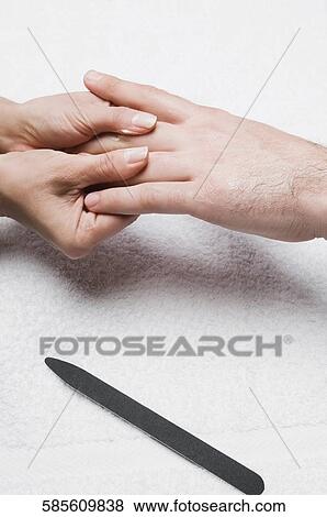Close-up of a woman's hand rubbing a man's hand View Large Photo Image Stock Photo - Close-up of a woman's hand rubbing a man's hand. Fotosearch