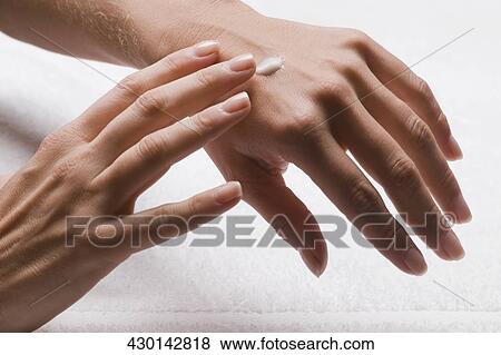 Close-up of a woman's hands applying lotion View Large Photo Image Stock Photo - Close-up of a woman's hands applying lotion. Fotosearch