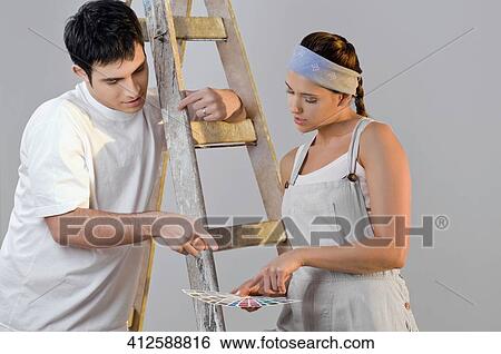 Close-up of a young couple choosing color from a color swatch View Large Photo Image Stock Photograph - Close-up of a young couple choosing color from a color swatch. Fotosearch