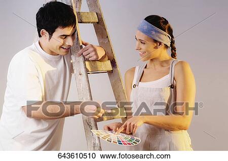 Close-up of a young couple holding color swatch and choosing color View Large Photo Image Stock Image - Close-up of a young couple holding color swatch and choosing color. Fotosearch