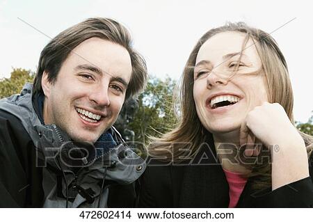 Close-up of a young couple smiling View Large Photo Image Picture - Close-up of a young couple smiling. Fotosearch