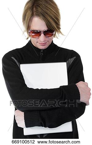 Close-up of a young man hugging a laptop and thinking View Large Photo Image Stock Image - Close-up of a young man hugging a laptop and thinking. Fotosearch