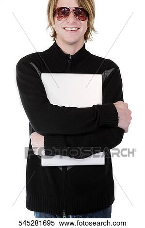 Close-up of a young man hugging a laptop and smiling View Large Photo Image Stock Photography - Close-up of a young man hugging a laptop and smiling. Fotosearch