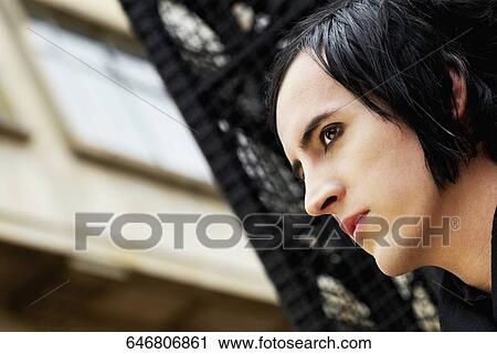 Close-up of a young man looking away View Large Photo Image Stock Image - Close-up of a young man looking away. Fotosearch