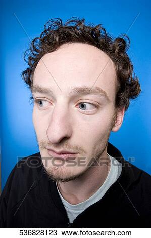 Close-up of a young man thinking View Large Photo Image Stock Image - Close-up of a young man thinking. Fotosearch