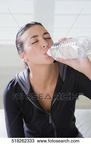 Close-up of a young woman drinking water View Large Photo Image Stock Image - Close-up of a young woman drinking water. Fotosearch