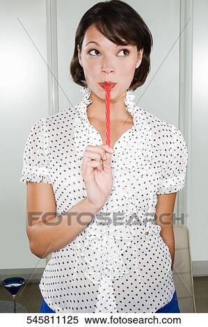 Close-up of a young woman eating licorice candy View Large Photo Image Stock Photography - Close-up of a young woman eating licorice candy. Fotosearch