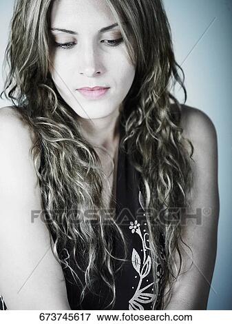 Stock Photo - Close-up of a young woman looking down. Fotosearch