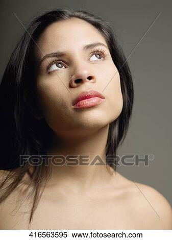 Close-up of a young woman looking up View Large Photo Image Stock Photography - Close-up of a young woman looking up. Fotosearch