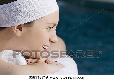 Close-up of a young woman lying on a massage table and smiling View Large Photo Image Stock Photo - Close-up of a young woman lying on a massage table and smiling. Fotosearch