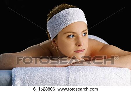 Close-up of a young woman lying on a massage table View Large Photo Image Stock Photograph - Close-up of a young woman lying on a massage table. Fotosearch
