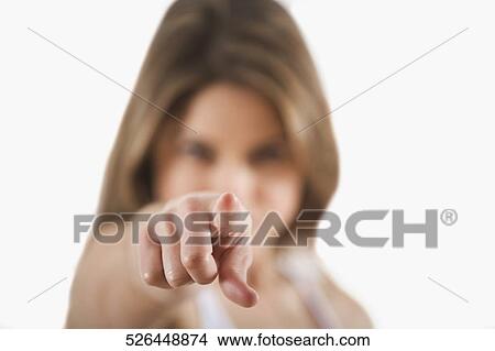 Close-up of a young woman pointing forward View Large Photo Image Picture - Close-up of a young woman pointing forward. Fotosearch