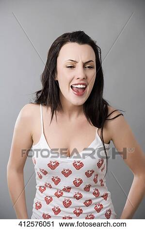 Stock Image - Close-up of a young woman shouting. Fotosearch