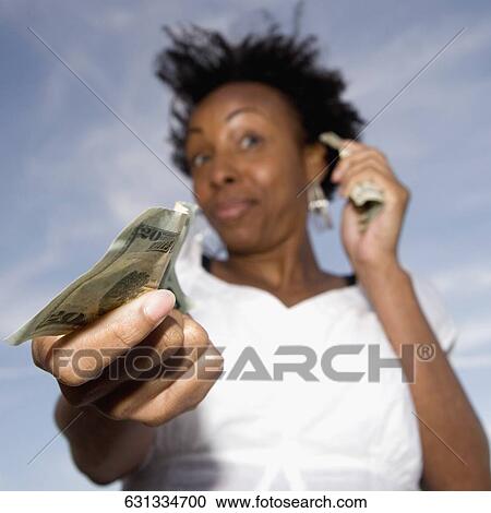Close-up of a young woman showing a twenty dollar bill View Large Photo Image Stock Image - Close-up of a young woman showing a twenty dollar bill. Fotosearch
