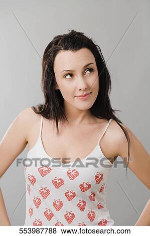 Close-up of a young woman smiling and looking up View Large Photo Image Stock Photo - Close-up of a young woman smiling and looking up. Fotosearch