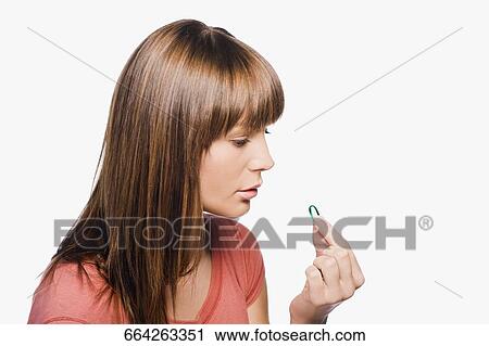 Close-up of a young woman taking a pill View Large Photo Image Stock Image - Close-up of a young woman taking a pill. Fotosearch