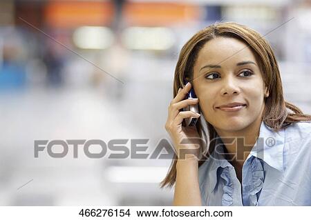 Picture - Close-up of a young woman talking on a mobile phone. Fotosearch