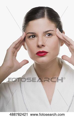 Stock Image - Close-up of a young woman thinking. Fotosearch