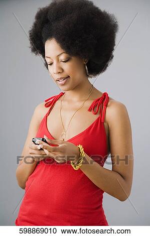 Close-up of a young woman using a mobile phone View Large Photo Image Stock Image - Close-up of a young woman using a mobile phone. Fotosearch