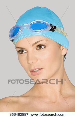 Close-up of a young woman wearing a swimming cap and thinking View Large Photo Image Stock Photo - Close-up of a young woman wearing a swimming cap and thinking. Fotosearch