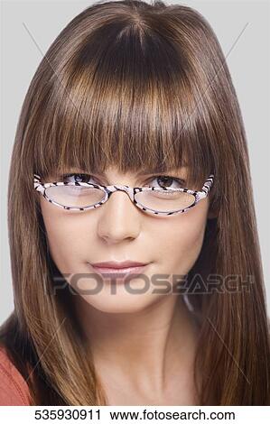 Stock Image - Close-up of a young woman wearing eyeglasses. Fotosearch