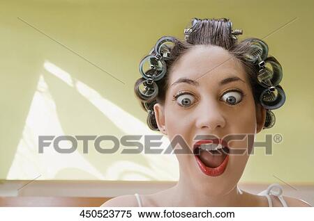 Stock Photography - Close-up of a young woman with her mouth open. Fotosearch